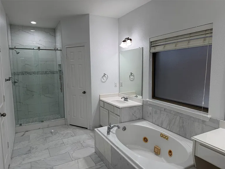 Ensuite bathroom with separate shower and jetted tub.