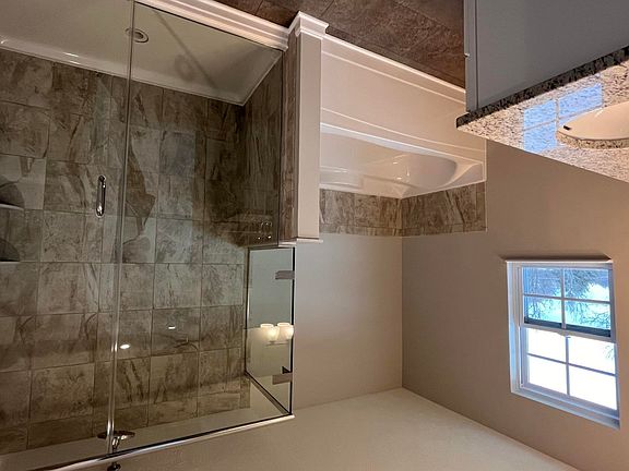 Master bathroom with tile shower and soak tub