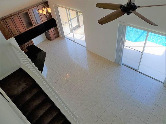2 story great room with 2 sets of sliders overlooking pool area and lake