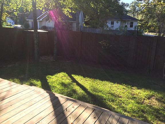 Fence in backyard with wood deck