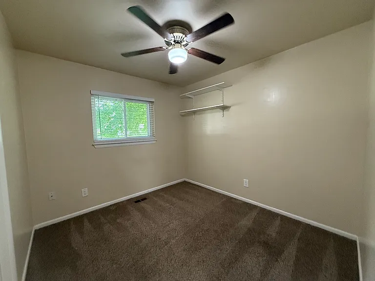 2nd bedroom, window overlooking Crab Apple St, Accent: small double shelf in corner of room