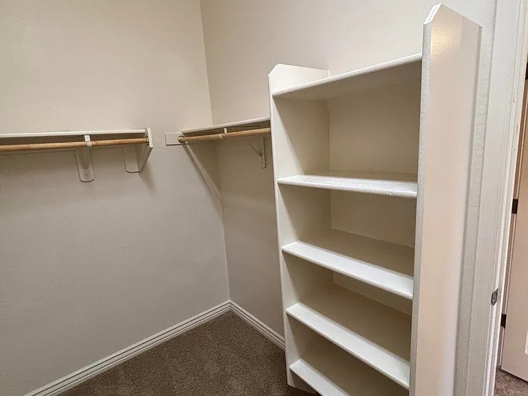 LARGE WALK IN CLOSET IN PRIMARY BEDROOM WITH BUILT INS.