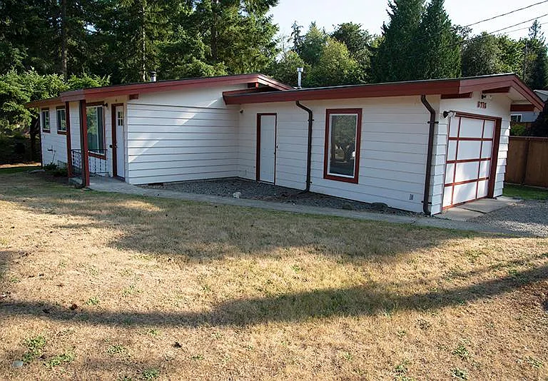 One car garage with work bench and man door