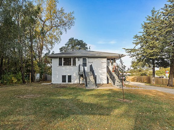 Well-maintained duplex featuring separate entries with maintenance-free stairs, large front windows, and a spacious yard, with lawn care and snow removal included for hassle-free living.