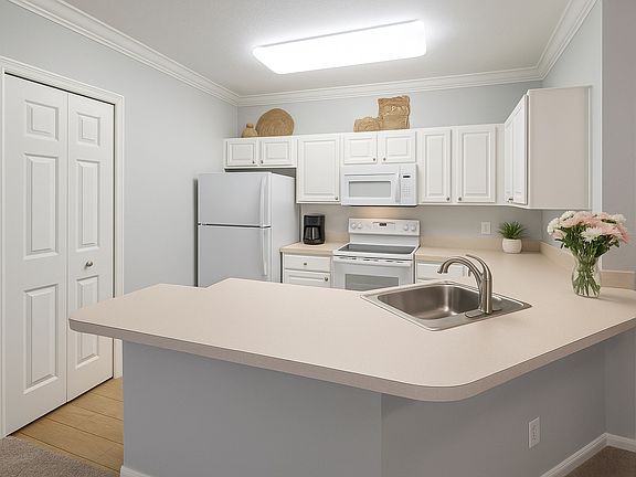 Kitchen with white cabinets, gas oven and stovetop