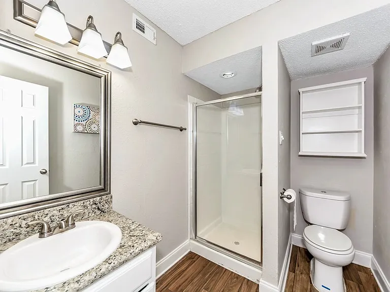 Clean, updated bathroom featuring modern fixtures and full shower.