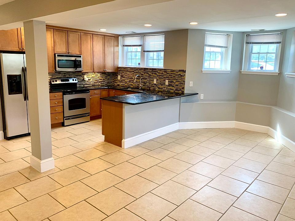 Open concept - large kitchen with breakfast bar, leads to open dinning and living room areas