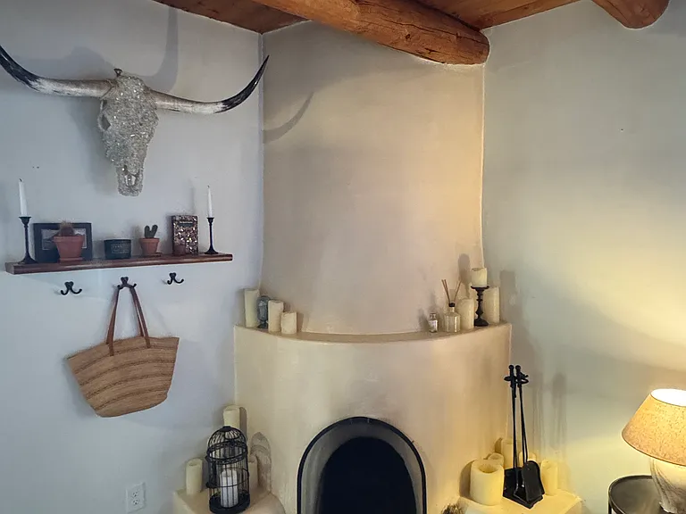 Cozy working Kiva fireplace adds warmth and historical character.