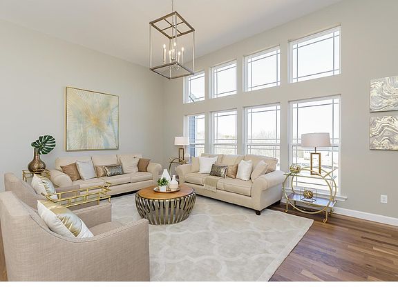 Great Room With Hard Wood Flooring and Large Window Wall
