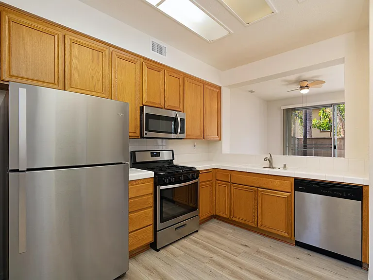 Stainless steel appliances and lots of storage in centrally located kitchen.