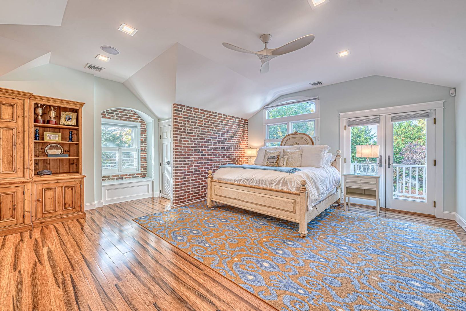  Primary bedroom with brick accent wall