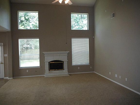 Large, spacious formal living room complete with clean, neutral carpet and fresh paint, and a cozy fireplace. Perfect for all types of entertaining.