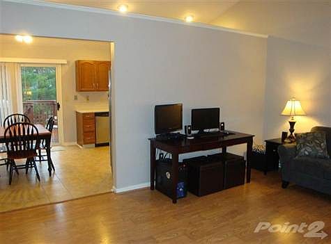 The living features newer laminate flooring and cathedral ceilings. The floorplan flows nicely into 