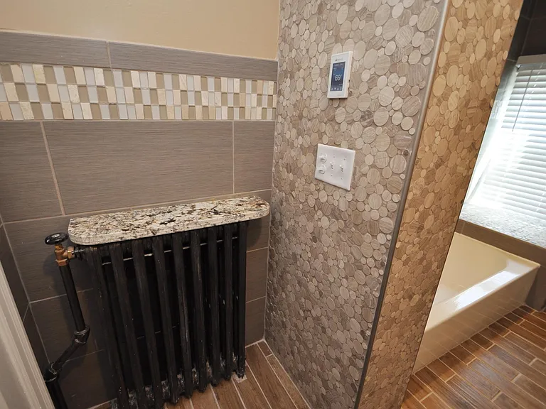 Marble, Granite, and porcelain Tile bathroom with heated floors and spa-quality fixtures and tile-work.