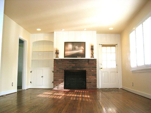 Formal Living room with accent lighting, fireplace, and built in shelves.