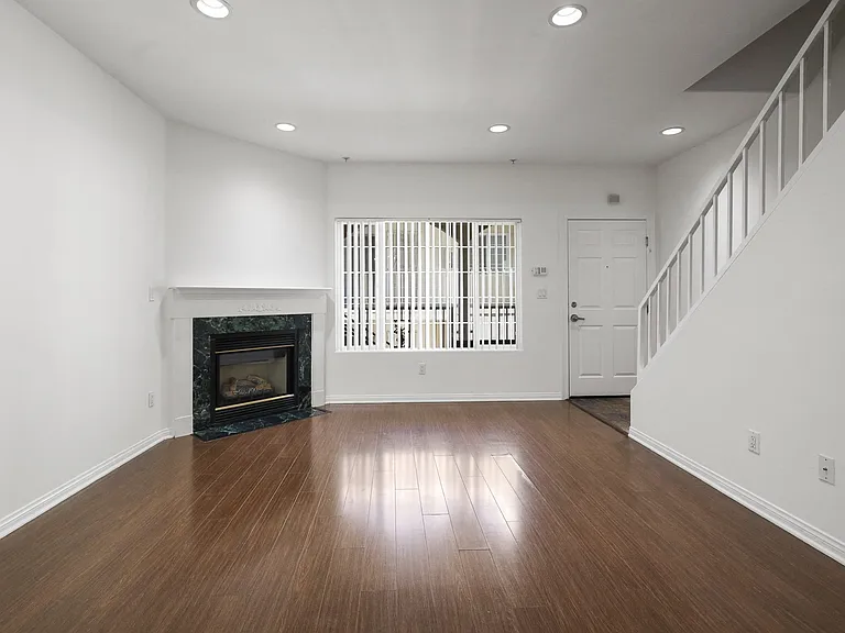 Living Room with Electric Fireplace, Recessed Lighting, Vinyl Flooring, and Patio