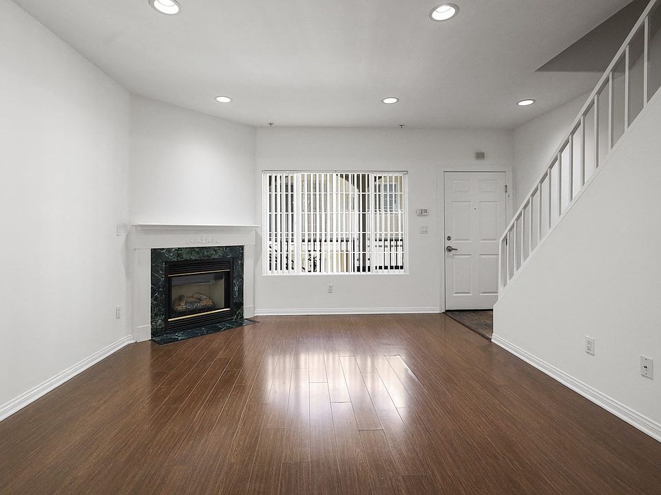 Living Room with Electric Fireplace, Recessed Lighting, Vinyl Flooring, and Patio