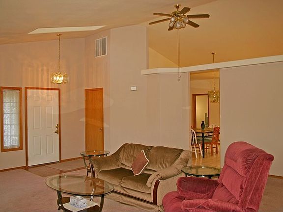 Beautiful warm living room with soaring cathedral ceilings w/unique details