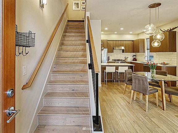 Radiant floor heat , a  breakfast peninsula , quartz counters, subway tile backsplash and panel cabinetry