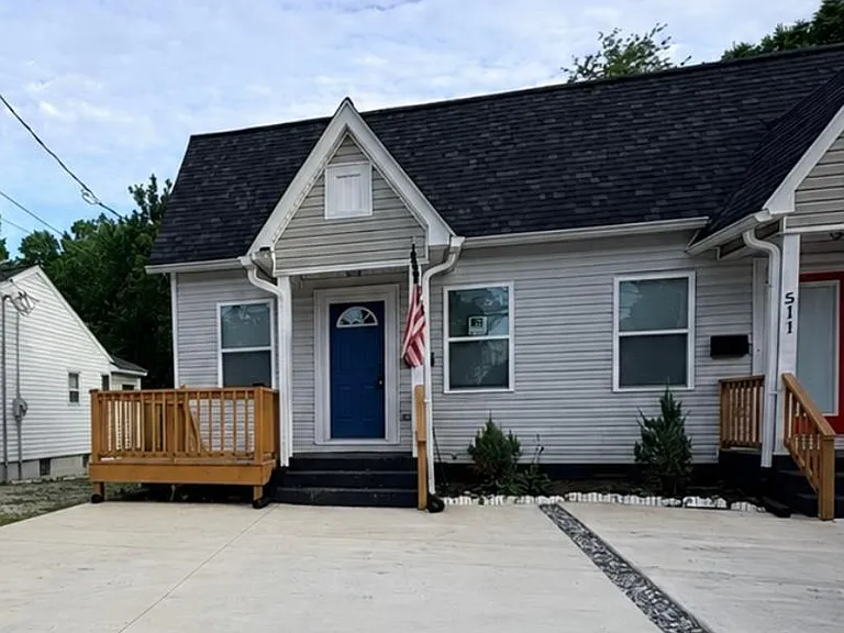 Charming front exterior with a wide concrete driveway, two entry porches, and low-maintenance siding for easy upkeep.