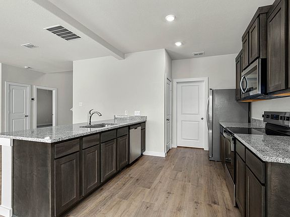 The kitchen has beautiful wood cabinetry.