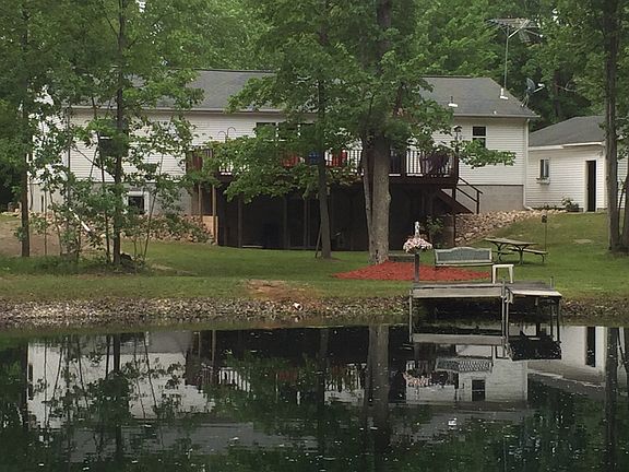Beautiful backyard with a fire pit and pond.. Sellers love to hunt and they don't even have to go fa