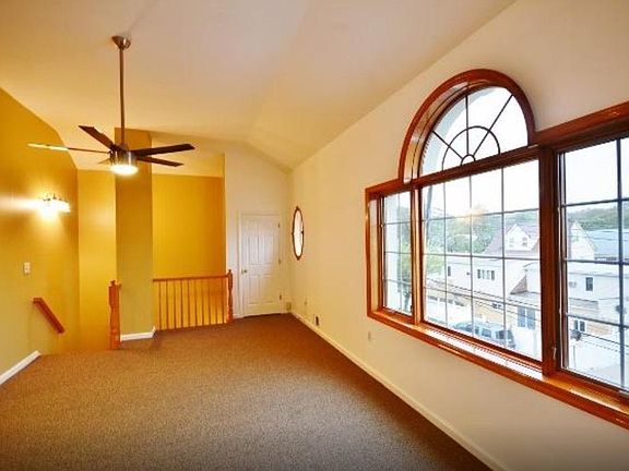 Living room and stair case to entrance