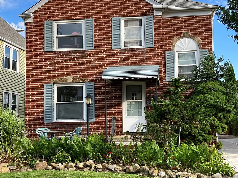 Front of house with front sandstone patio (in bottom left of photo)