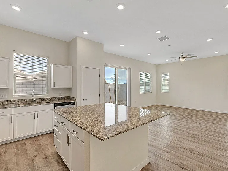 Explore this elegant open kitchen and living space, perfect for modern living.