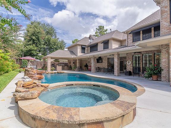 Another view of this beautiful backyard oasis with a view of the recently added outdoor kitchen.