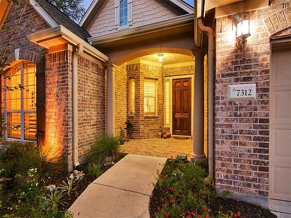 The lovely landscaping welcomes you to the front of the home.