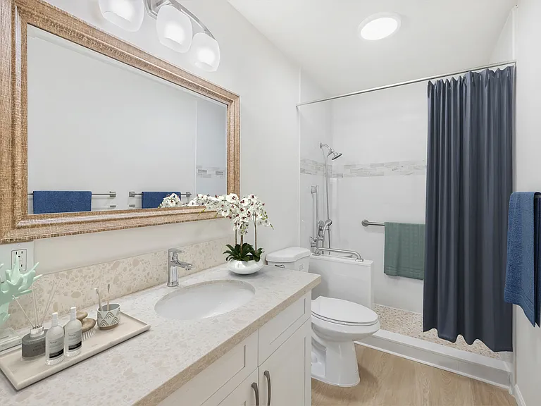 Hall bathroom with updated vanity, counter & shower.