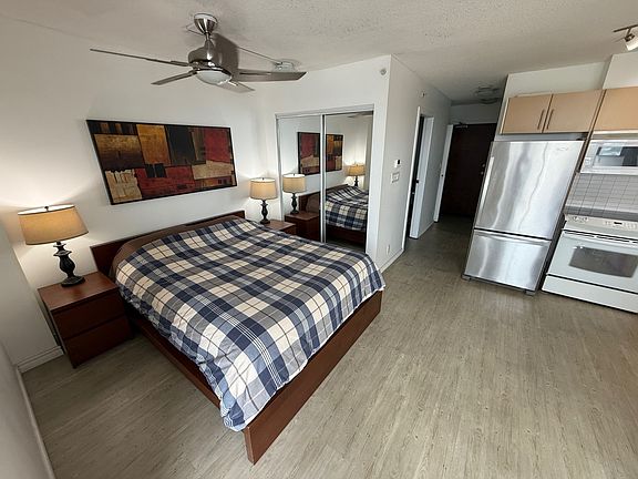 Bedroom area with mirrored closet for clothes and storage.