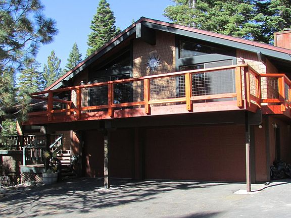 sunny exterior with large two car garage