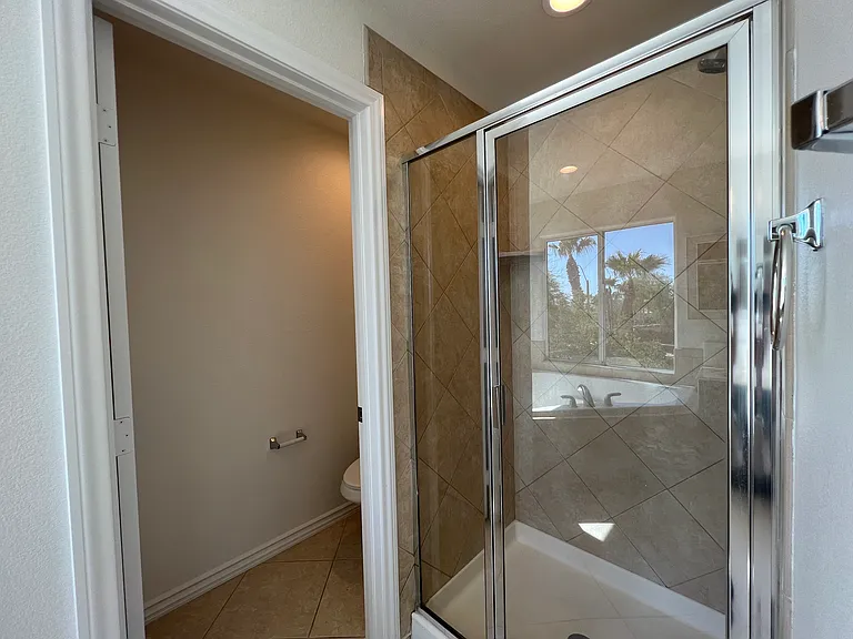 Primary bath's shower and water closet.