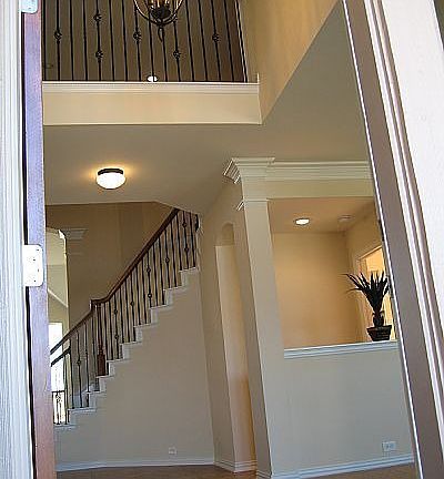 Dramatic entry with double crown moulding and 18" tiles