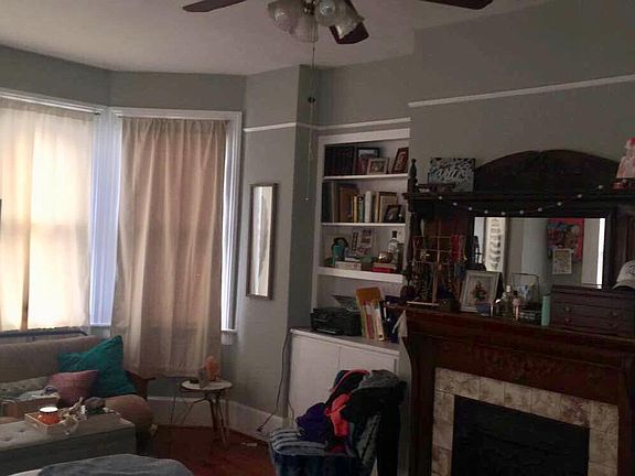Downstairs bedroom with mantel, built in shelves, large bay window