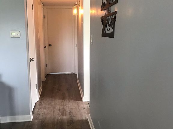 Hallway to 2 bedrooms, linen closet and pantry