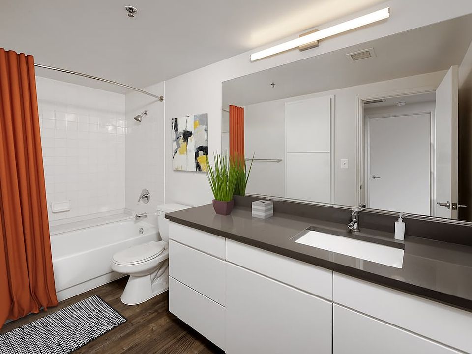 Renovated Package III kitchen, living, and dining areas with hard surface flooring