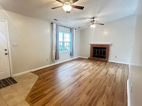 Living room featuring cathedral ceilings & 2 ceiling fans