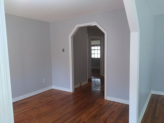 Dining room looking through hallway to 1 bedroom on left