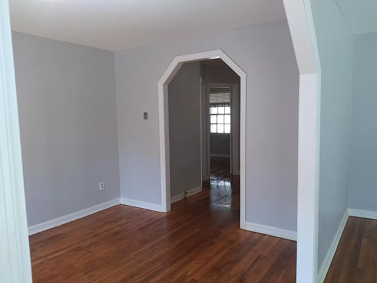 Dining room looking through hallway to 1 bedroom on left