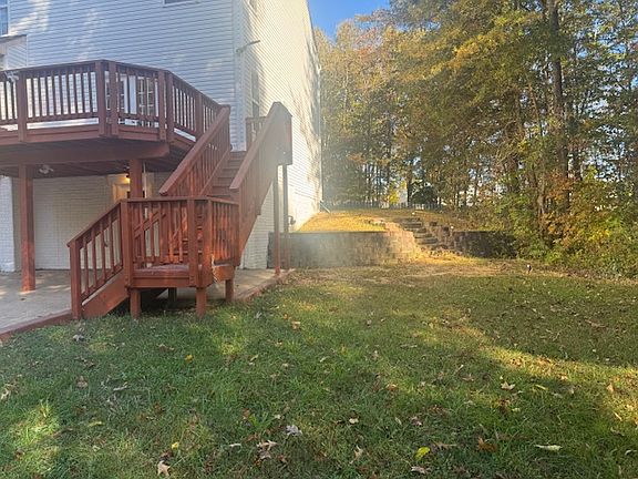 Grass area and stairs to the front of driveway
