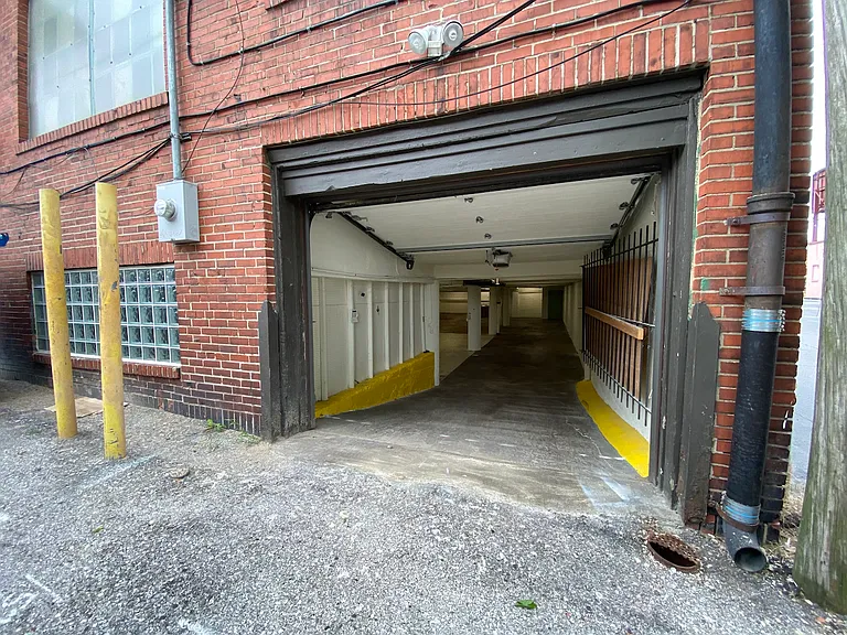 Drive-In Door: 9'2" W x 7'H overhead garage door. Located in the alley off of Tholozan.