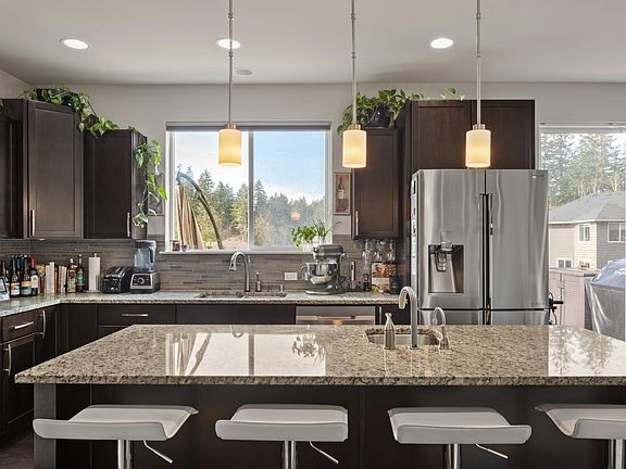 Kitchen island bar with sink and instahot; watch your children play in the community park from the kitchen window, deck or living room