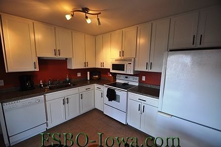 Kitchen - New cabinet doors, hardware, countertop, tile floor, lighting and appliances.
