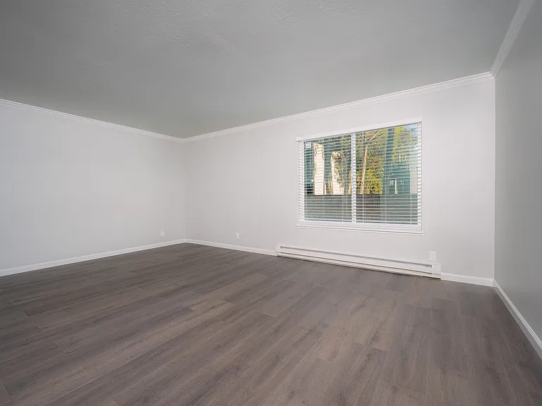 Experience the spacious elegance of this modern living room, filled with natural light.