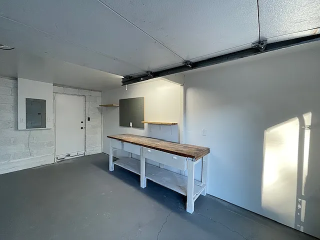 Large garage with plenty of work space and storage options. Finished/painted floor, walls and ceiling. Task lighting at the work bench with multiple outlets.