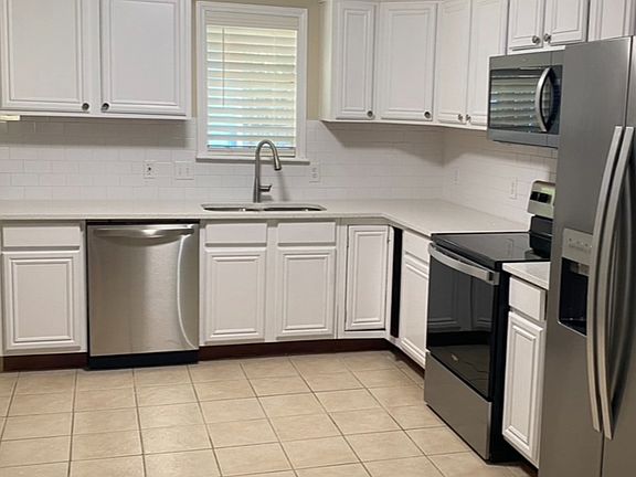 Kitchen with quartz counter top and stainless steel appliances.