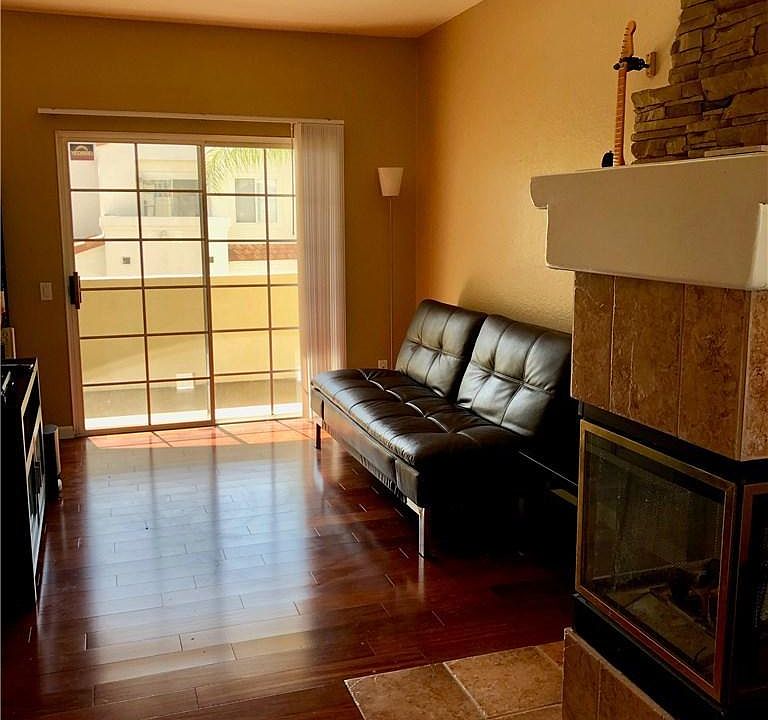 The living room and fireplace. The patio door leads to one of the three balconies on the unit